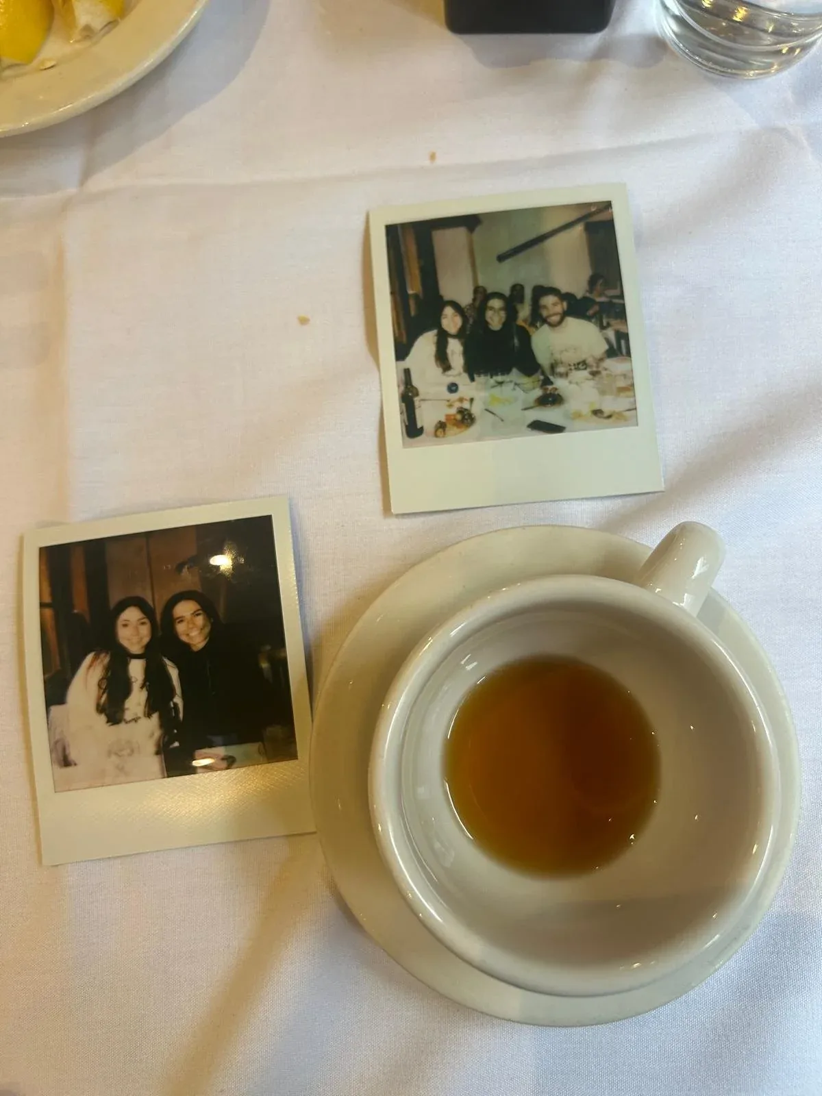 Polaroid photos of lab members next to a cup of coffee