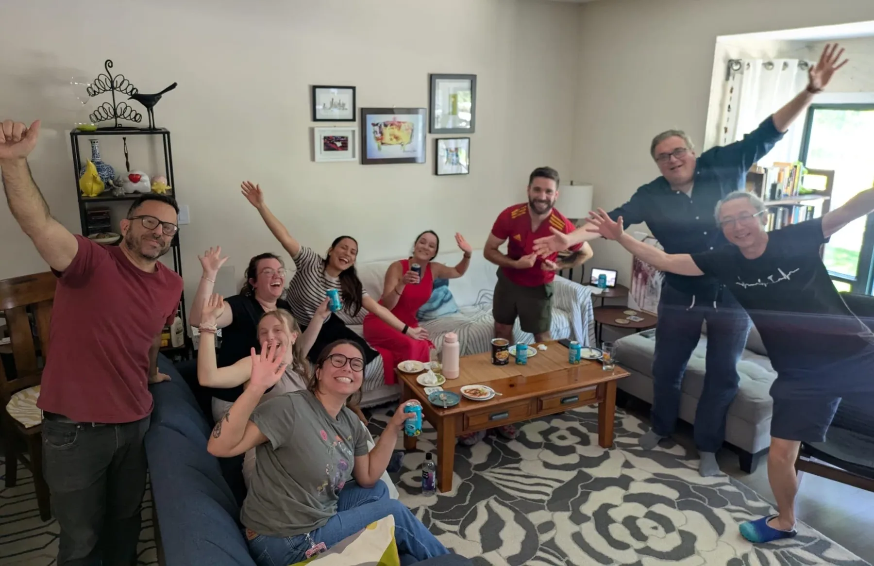 Lab members and friends cheering in a living room