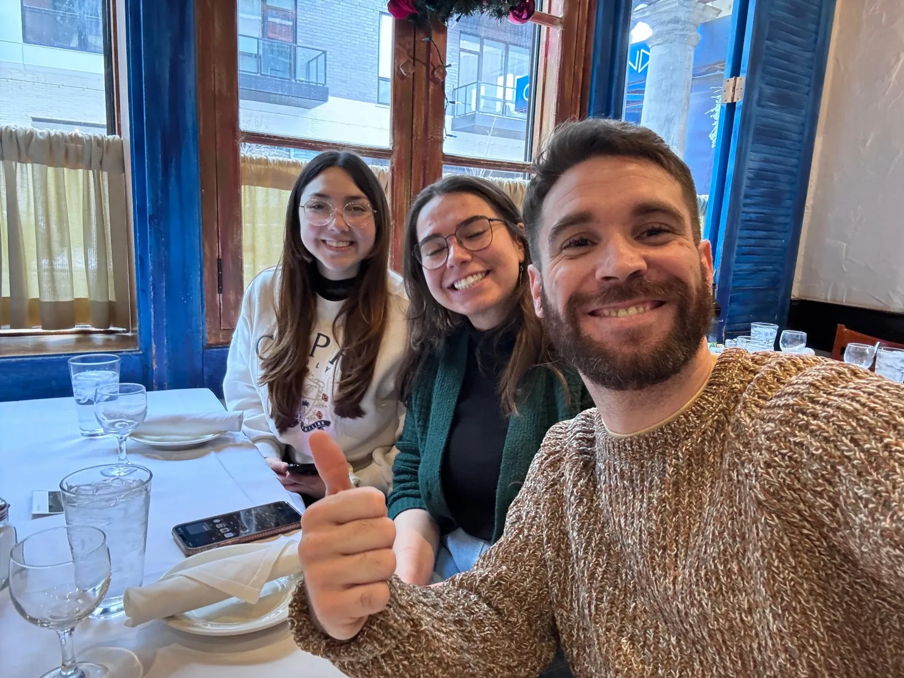 Lab members smiling at a restaurant table during the first lab outing