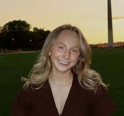 Caitlin Madden on a lawn at sunset