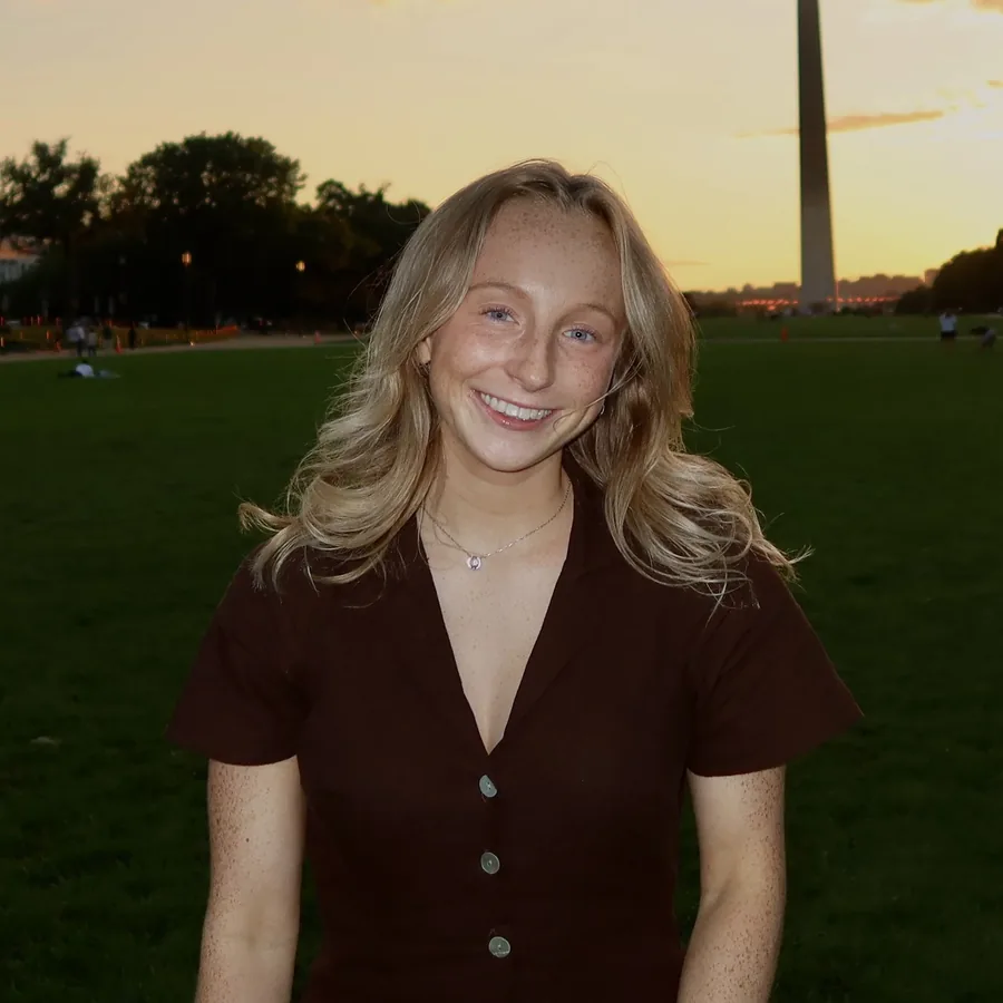 Caitlin Madden on a lawn at sunset