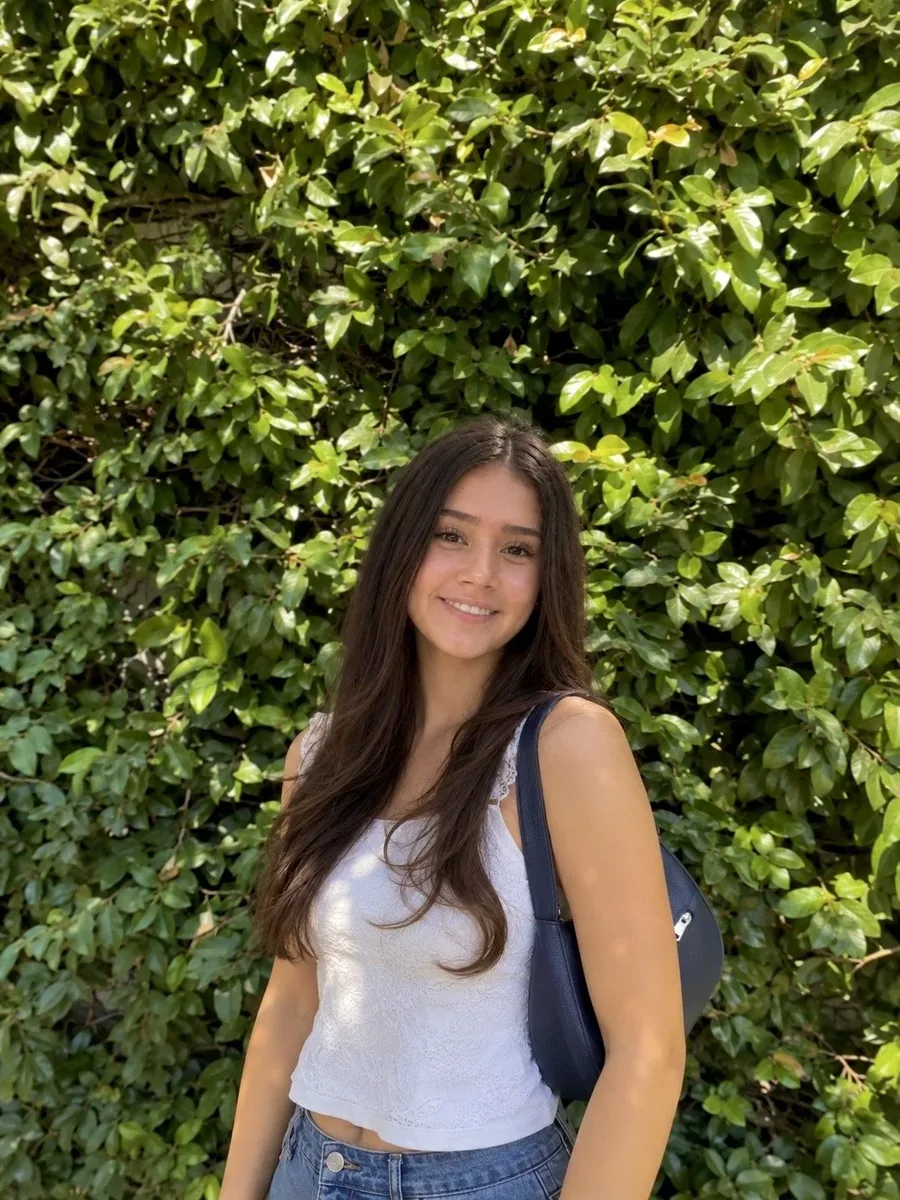 Giovanna Cuevas in front of an ivy wall