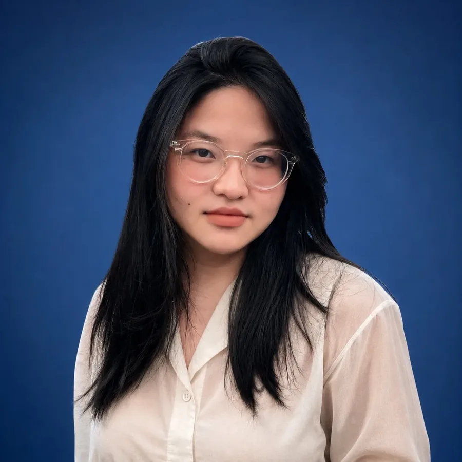 Ngoc Dang in front of a blue backdrop